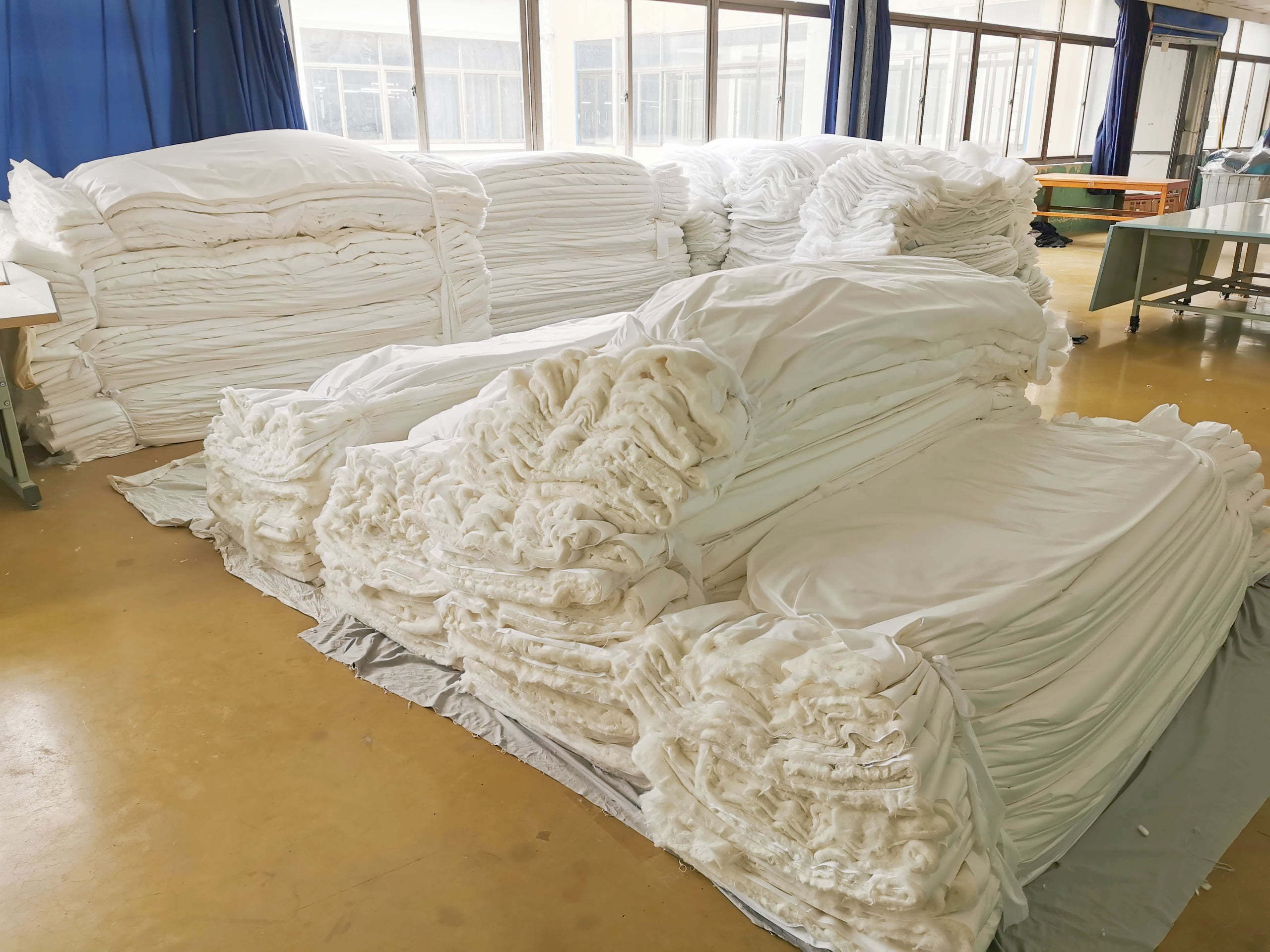 Skilled artisans stitching premium bedding